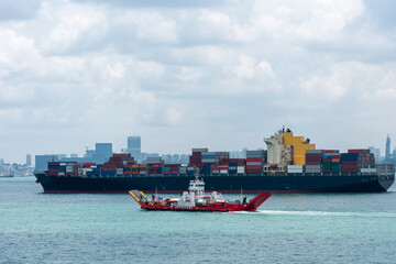 Cargo container ship anchored at road of Singapore. She is waiting to enter cargo terminal.