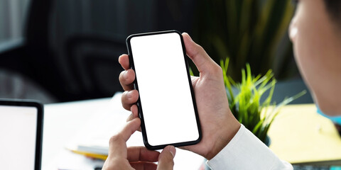 Businessman using smartphone blank screen frameless modern design at home office