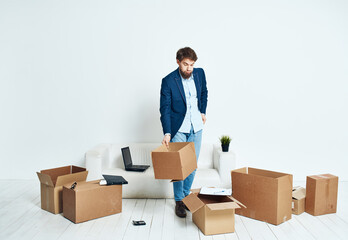 Business man in a suit boxes in hands picking things moving