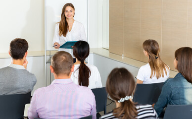 Naklejka na ściany i meble Confident young businesswoman presenting new business project to partners in modern office..