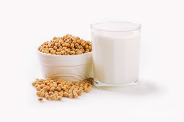 Glass of soy milk with soybean in ceramic bowl isolated on white background.