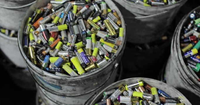 Lots of used batteries sorted into buckets. Top view. Recycling. Environmental protection concept.