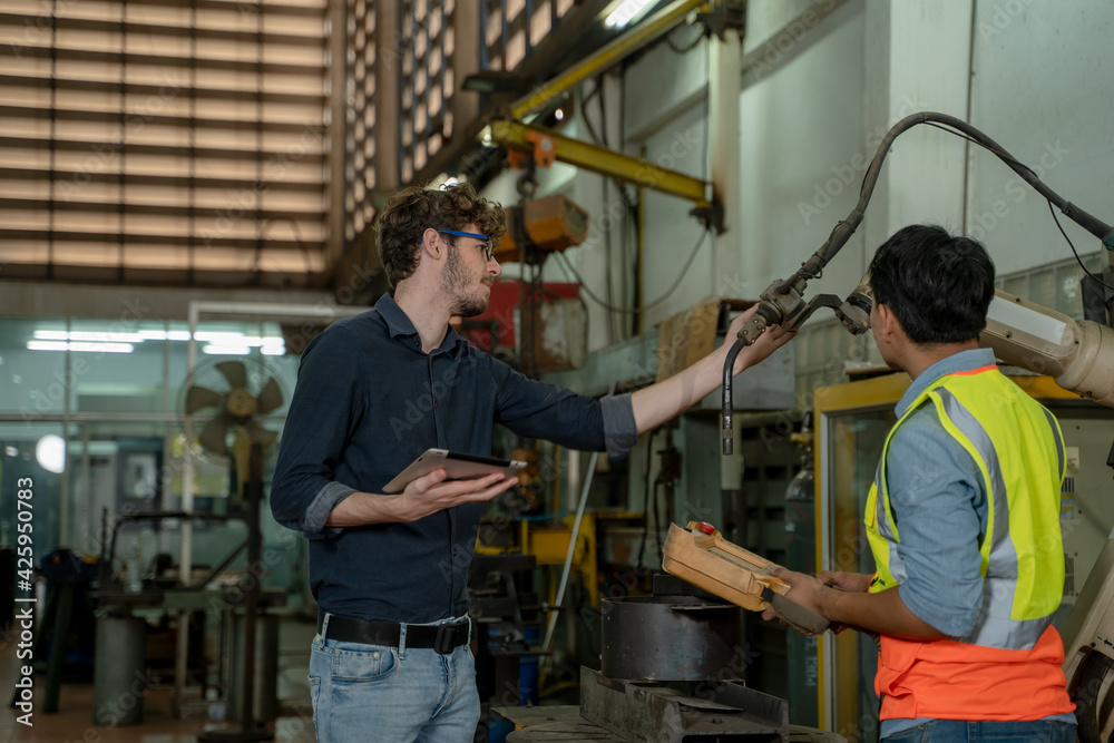 Poster factory engineer working together and having discussion in factory,technical specialist mechanics at