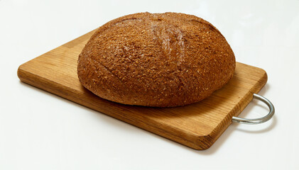 Loaf of bread on wooden cutting board on white background
