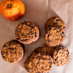 Cookies with chocolate icing, orange, on a white and black background, copy space, template