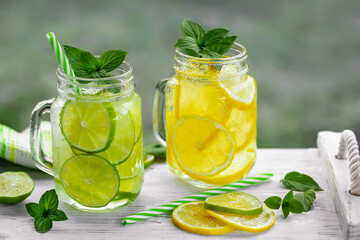 Cold refreshing homemade lemonade with mint, lemon and lime in mason jars