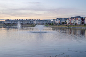 Residential complex apartments with lake and fountains in foreground