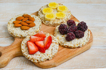 cereal breakfast crisp breads with strawberries, almonds nuts, banana fruit and blackberries