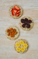 Fototapeta premium cereal breakfast crisp breads with strawberries, almonds nuts, banana fruit and blackberries