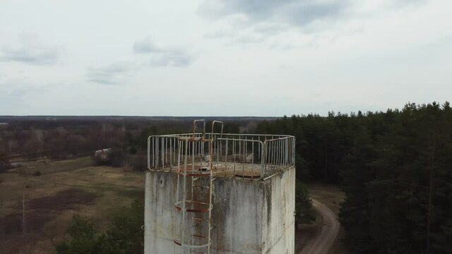 Aerial view of old abandoned ussr tower in forest. Chernobyl, Ukraine. Military tower. Post-soviet architecture 
