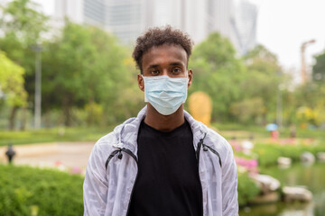 Portrait of handsome black African man wearing face mask