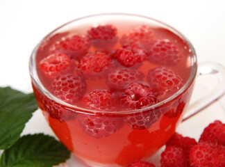 tea with raspberries on a white background