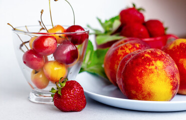 summer fruit and berries still life, ripe nectarines closeup, healthy nutrition concept, organic strawberry and cherry