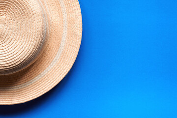 Fototapeta na wymiar Pretty straw hat for outdoor.On blue background