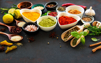 Various spices in a bowls on a black