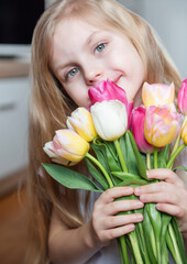 Spring tulips in the hands of a little girl.
