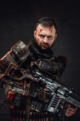 Serious military guy with shotgun in dark background