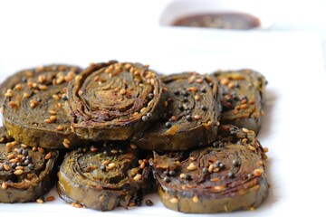 Alu Vadi, Patra, paatra, colocasia leaves roll, Patrode is a popular Indian healthy steamed snack. Garnished with sesame and mustard seeds. served with tamarind chutney. copy space.
