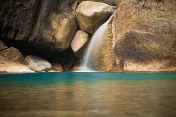 Fototapeta na wymiar A serene waterfall and a lagoon on the way to rainbow falls in Meghalaya.