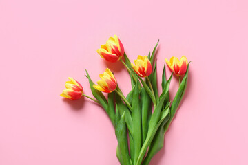 A bouquet of tulips as a gift for March 8, Mother's Day, Valentine's Day. Easter decor. Top view. Flowers tulips on a pink background.
