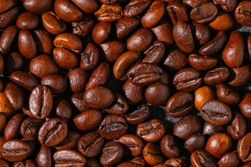 Roasted brown coffee beans. Top view. Coffee background texture.