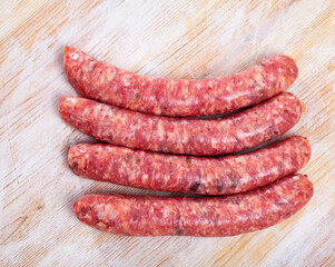 Uncooked sausages on wooden table. High quality photo