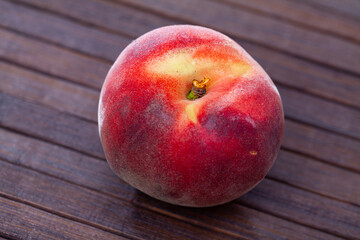 Fototapeta na wymiar Closeup of whole ripe red peaches on wooden table. Vitamin fruits