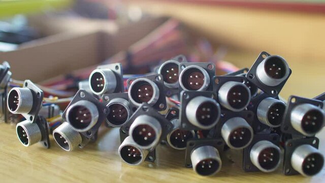 Slider shot video of blurry metal sockets for plugs are in a heap. Concept for the production of computer televisions and audio speakers