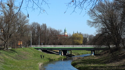 Fototapeta na wymiar Landscape with a river and a bridge on a sunny day in the city of Lublin. 2