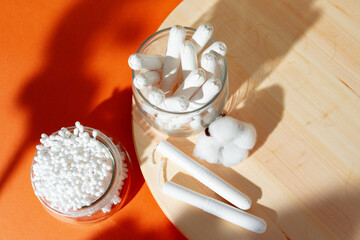 Cotton tampons and ear buds on paper background
