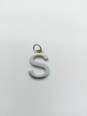 metal alphabet locket closeup on white background