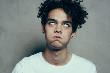 emotional man curly hair white t-shirt close up