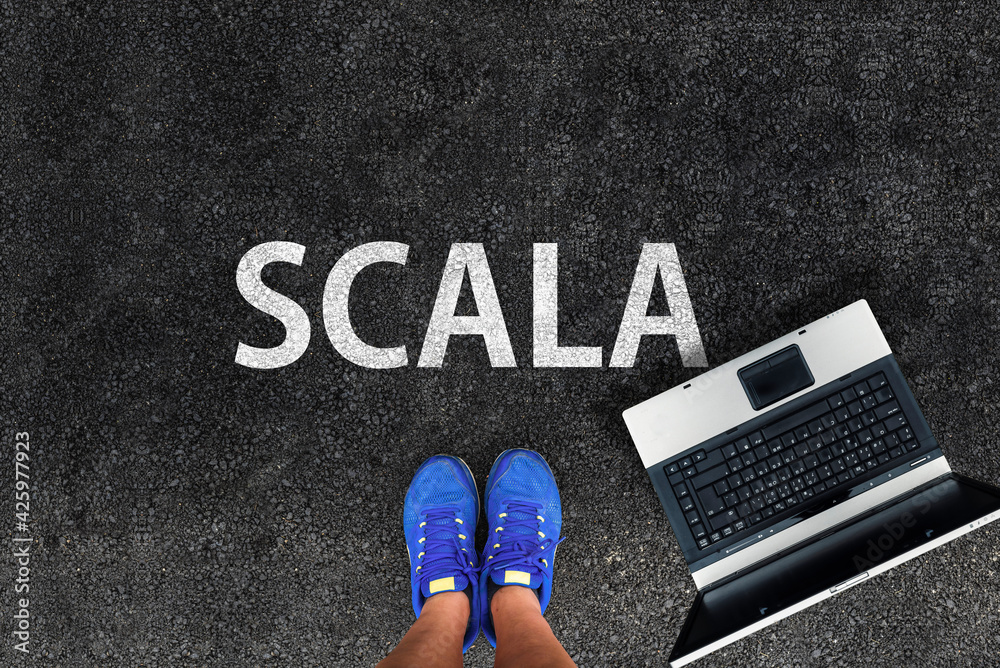 Poster scala programming language. man legs in sneakers standing next to laptop and word scala