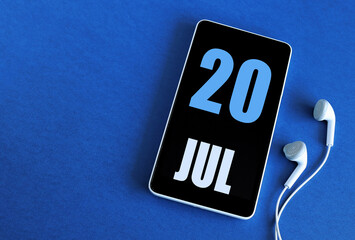 July 20. 20 st day of the month, calendar date. Smartphone and white headphones on a blue background. Place for your text. Summer month, day of the year concept