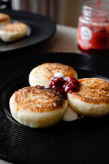 cheesecakes with strawberry jam on a plate
