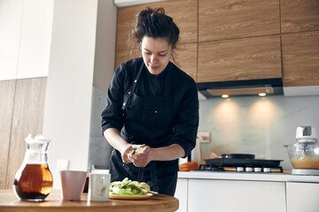 beautiful middle asian woman preparing apples for cooking at cozy stilysh kitchen