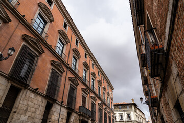 Old Traditional Residential Buildings in Central Madrid. Colorful Facades Against Cloudy Sky