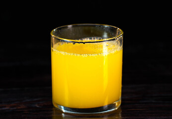 glass of fresh orange juice on a vintage wooden background. Close up shot. healthy lifestyle. healthy eating. vitamins