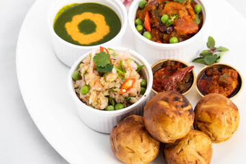 Litti Chokha Or Liti Choka From Bihar Jharkhand And Uttar Pradesh UP Is Stuffed With Chana Sattu. Served With Alu Or Aloo Baingan Bharta Desi Ghee Lehsun Adrakh Lehsoon Chutney Achar Mirchi And Pyaj