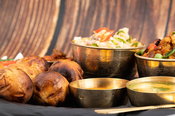 Litti Chokha Or Liti Choka From Bihar Jharkhand And Uttar Pradesh UP Is Stuffed With Chana Sattu. Served With Alu Or Aloo Baingan Bharta Desi Ghee Lehsun Adrakh Lehsoon Chutney Achar Mirchi And Pyaj
