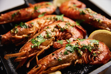 Grilled large shrimps with lemon and spices on the grill pan