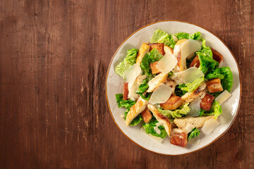 Caesar salad with chicken, top shot with a place for text