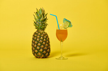 Composition of a pineapple and delicious juice or cocktail in glass decorated with straw and...