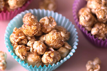 Sweet caramel popcorn in a colorful cups