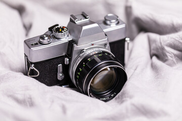 Old retro camera on vintage on gray textile background