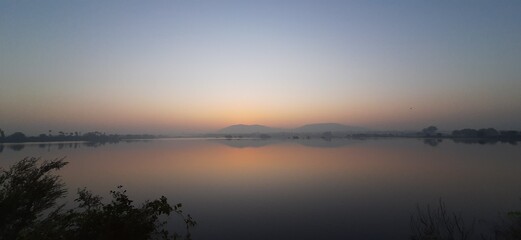 Fototapeta na wymiar Sunrise over lake With Early Morning 