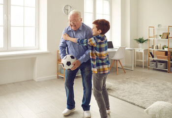 Happy excited grandpa celebrates Grandparents Day and enjoys sports games together with his...