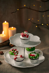 Christmas sweets: cupcakes closeup on a linen background.
