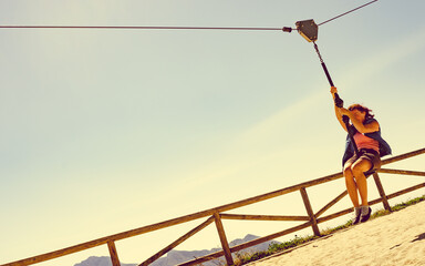 Naklejka premium Adult woman having fun on zipline