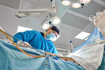 surgeon during liposuction in the operating room